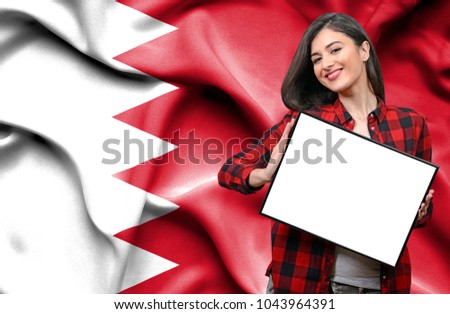 Woman holding blank board against national flag of Bahrain
