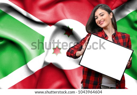 Woman holding blank board against national flag of Burundi