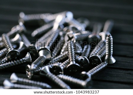 Pile of metal nail screw closeup macro view blur background