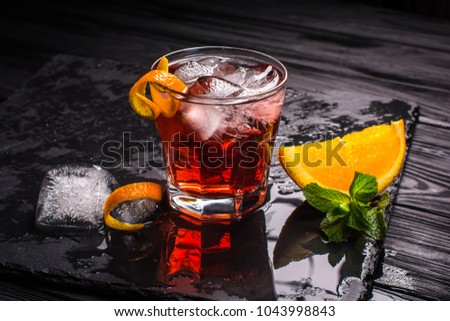 Mezcal Negroni cocktail. Smoky Italian aperitivo. Royalty-Free Stock Photo #1043998843