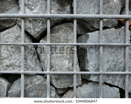 stones behind steel grid