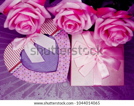 love mother's day gift box with rose flowers background 