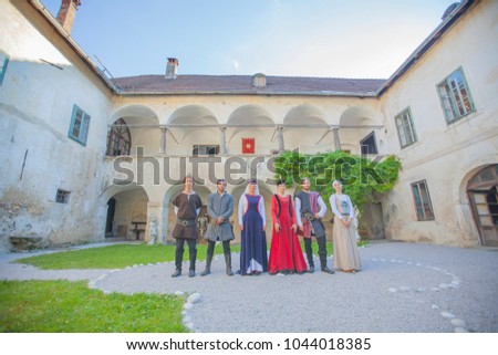 Knights and princesses are standing inside the courtyard