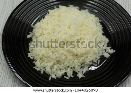 Cooked Rice in a bowl, placed on the top corner of the white background