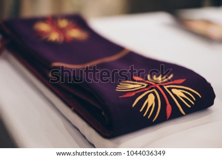 Clergy stole for priests and deacons. Selective focus. Copy space.  Royalty-Free Stock Photo #1044036349