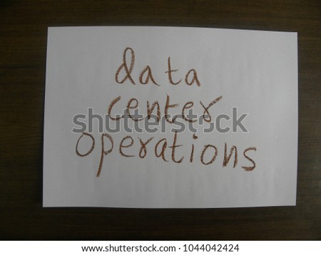 Text data center operations hand written by brown oil pastel on white color paper