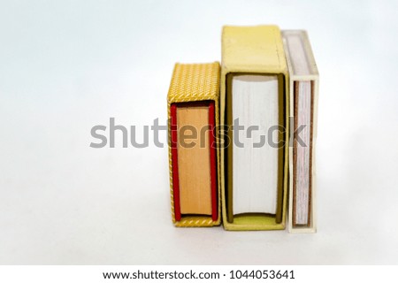 Stack of small books in hard cover on a white background