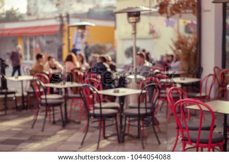 Defocused view to outdoors street cafe people enjoying sunny Sunday in Tirana, Albania capital
