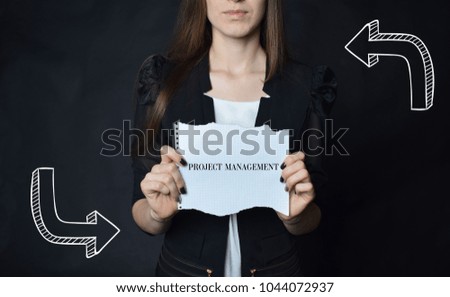 In the hands of a businessman a scrap of paper with the inscription:PROJECT MANAGEMENT