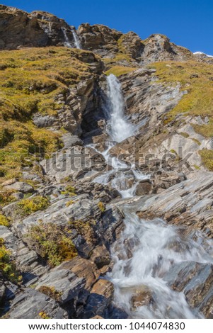 Picturesque Alpine waterfall, Grossglockner High Alpine Road in Austrian Alps close to Kaiser Franz Josef glacier.