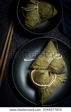 Zongzi or Traditional Chinese Sticky Rice Dumplings (Dark Food Photography)