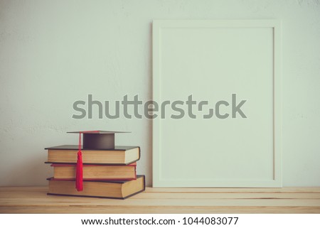 Photo frame and books, graducation hat on white wall background, creative ideas back to school concept - Retro tone