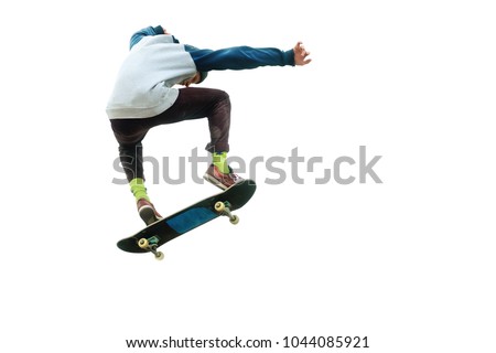 A teenager skateboarder jumps an ollie on an isolated white background. The concept of street sports and urban culture Royalty-Free Stock Photo #1044085921