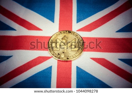 Physical version of golden Monero coin (new virtual money) and England Flag