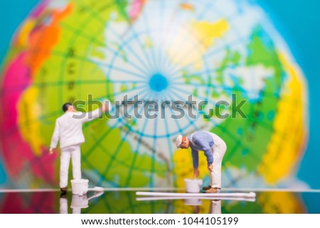 Miniature people : Painters painting on The globe  background , Earth day concept