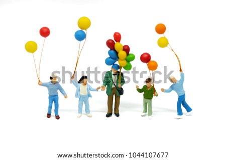 miniature people, Happy family and children enjoy with colorfull balloons standding on white blackground. Picture use for holliday concept.