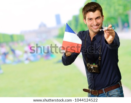 Photographer Holding French Flag And Miniature Airplane, Outdoor