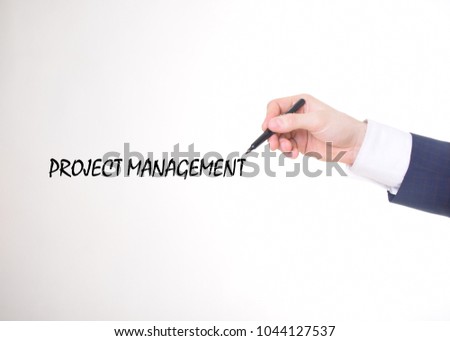 The businessman writes a black marker inscription:PROJECT MANAGEMENT