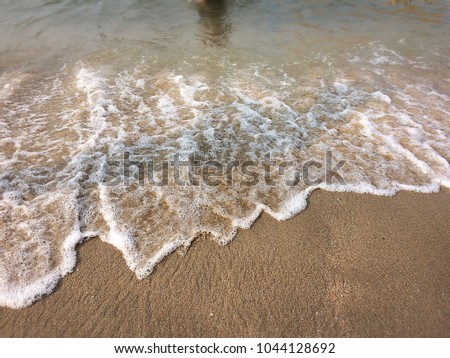 The background of sand and wave from the sea.
