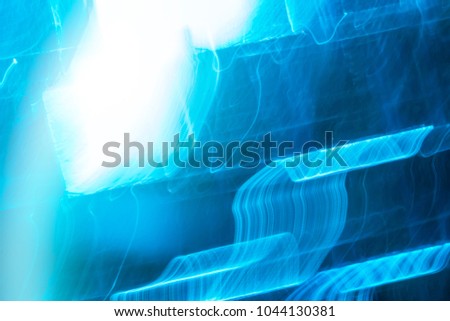 Abstract background of blue neon glowing light shapes. Bright stripes  Can use for poster, website, brochure, print.