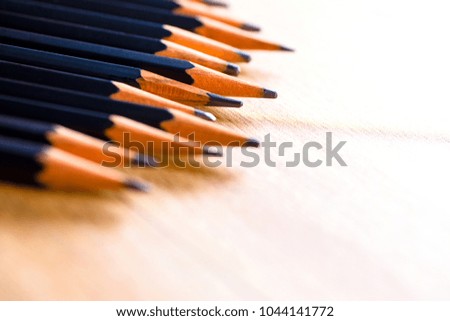 black pencils isolated on wood surface background.Close up.