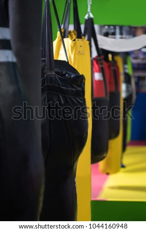 Punching bags in a row. A lot of Boxing mixed pears in the gym