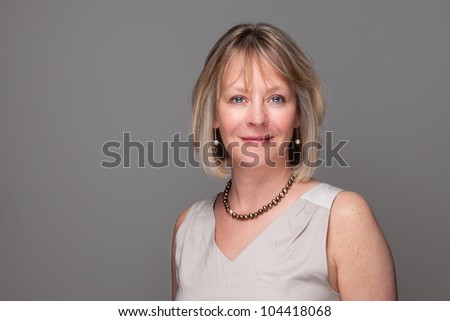 Head Shot Portrait of Attractive Smiling Elegant Woman on Grey Background Royalty-Free Stock Photo #104418068