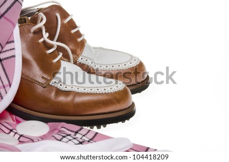 Ladies golf shoes and pink plaid outfit.  Image isolated against white background.