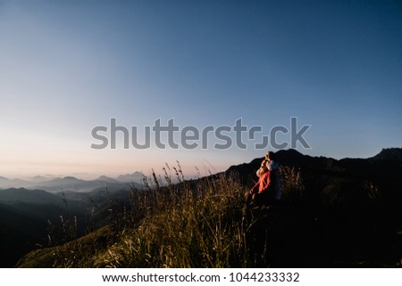 Beautiful couple on the mountain on sunset 