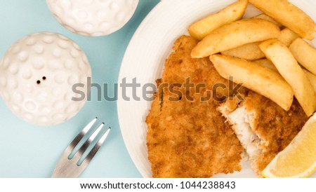Traditional British Favourite, Popular Fish And Chips Meal, With A Slice Of Lemon, Against A Blue Background, Top View Close Up With No People