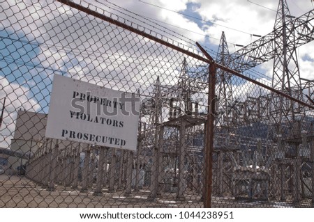 A property violators prosecuted sign outside of an electrical power substation 