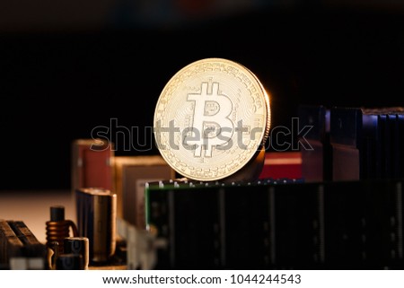 Photo of crypto currency, bitcoin and processor on orange, background