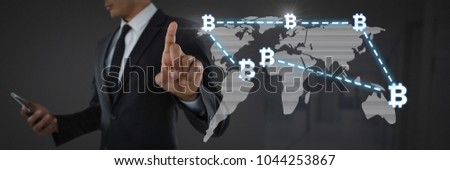 Digital composite of Businessman touching bit coin graphic icons on world map
