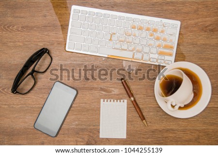 Coffee spilled on the keyboard, close the picture. Damaged computer in need of reimbursement. Data security and concept. unsuccessful person. wooden background