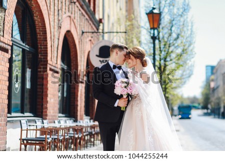 Newlyweds are walking the streets on their wedding day