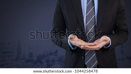 Digital composite of Businessman with hands palm open and dark background