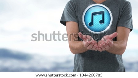 Digital composite of Music note icon and hands palm open in landscape