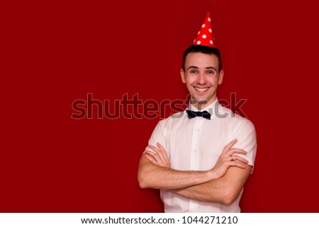 Happy man in white shirt and red cap isolated on red background looking in camera. Photo for business projects, product presentation. Image with copy space isolated on red