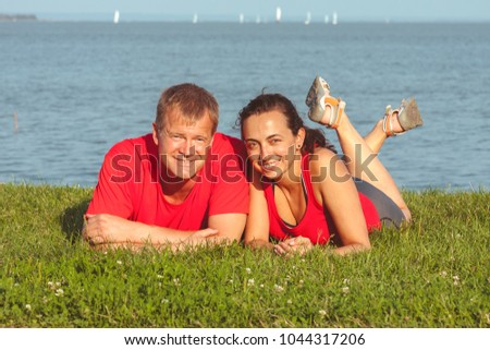 Young couple lies on the shore in lake Balaton in Hungary