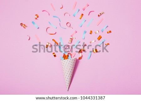 birthday hat with confetti on paper background