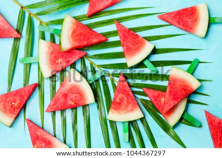 Watermelon slices on blue background. Top view. Copy space.