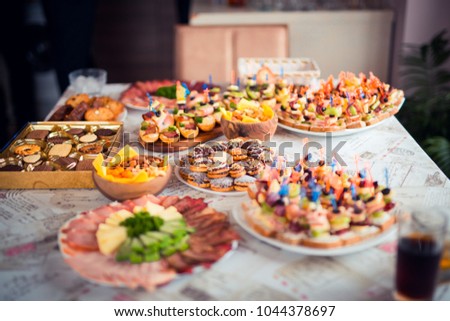 a rich table with delicious and different party bites Royalty-Free Stock Photo #1044378697