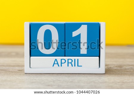 April 1st. Day 1 of april month, calendar on yellow background. Spring time, Easter and fools day Royalty-Free Stock Photo #1044407026