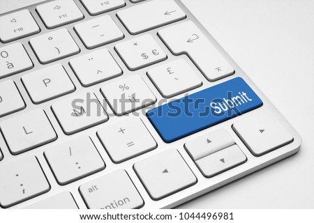 Blue Submit push button on a white keyboard Royalty-Free Stock Photo #1044496981