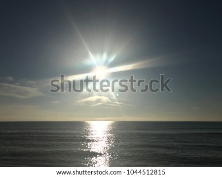 Bright Sun over Calm Ocean 