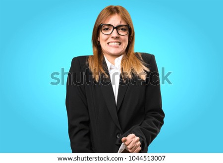 Angry young business woman shouting on colorful background