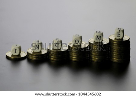 income text letter on a wooden cubes and money stack