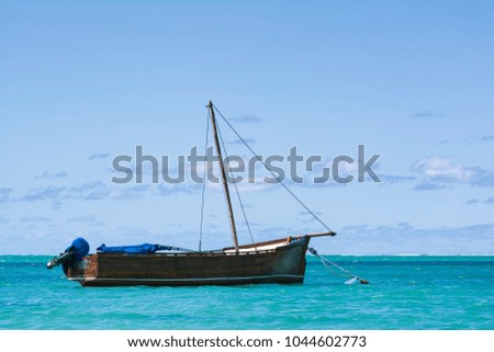 Mauritian traditional boat floating in Ocean