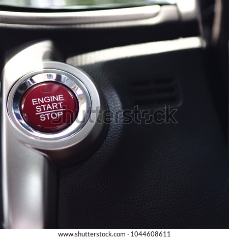 Closeup start button red color for start and stop engine in the car,Black and silver color interior smart car