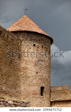 Old castle tower and wall with sky on background 